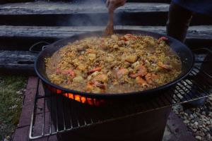 Cooking paella over a fire barrel in the back yard