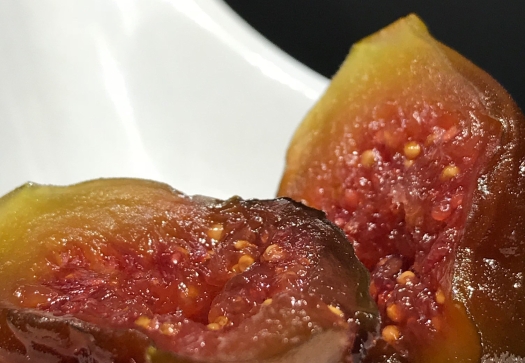 A candied fig on a white spoon